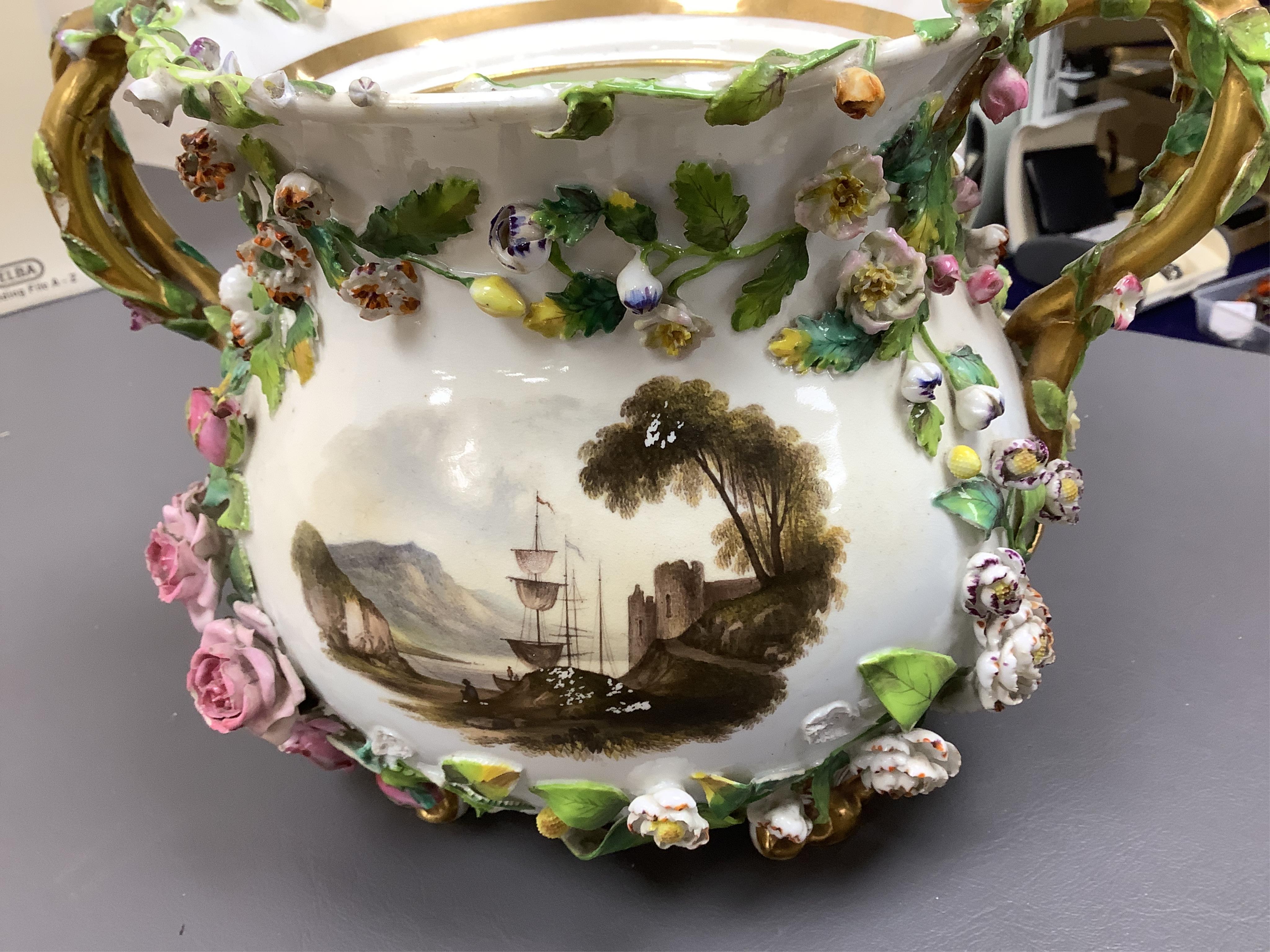 A pair of Rockingham two handled pot pourri vases and covers, c.1830-42, the first painted with two named views near Lyme, Dorsetshire and Stockly Bridge’, The second with an unnamed view of a monument by a lake, the rev